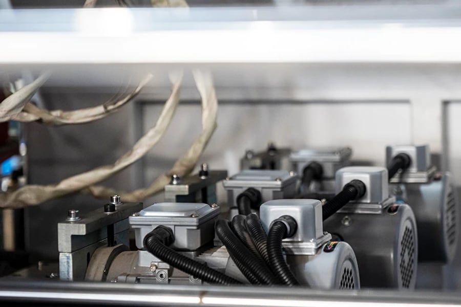 Drive components and adjustment hardware inside a plastic pipe belling machine